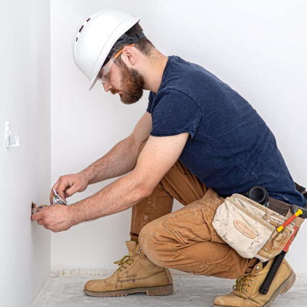 professional-overalls-with-electrician-s-tool-white-wall-background-home-repair-electrical-installation-concept